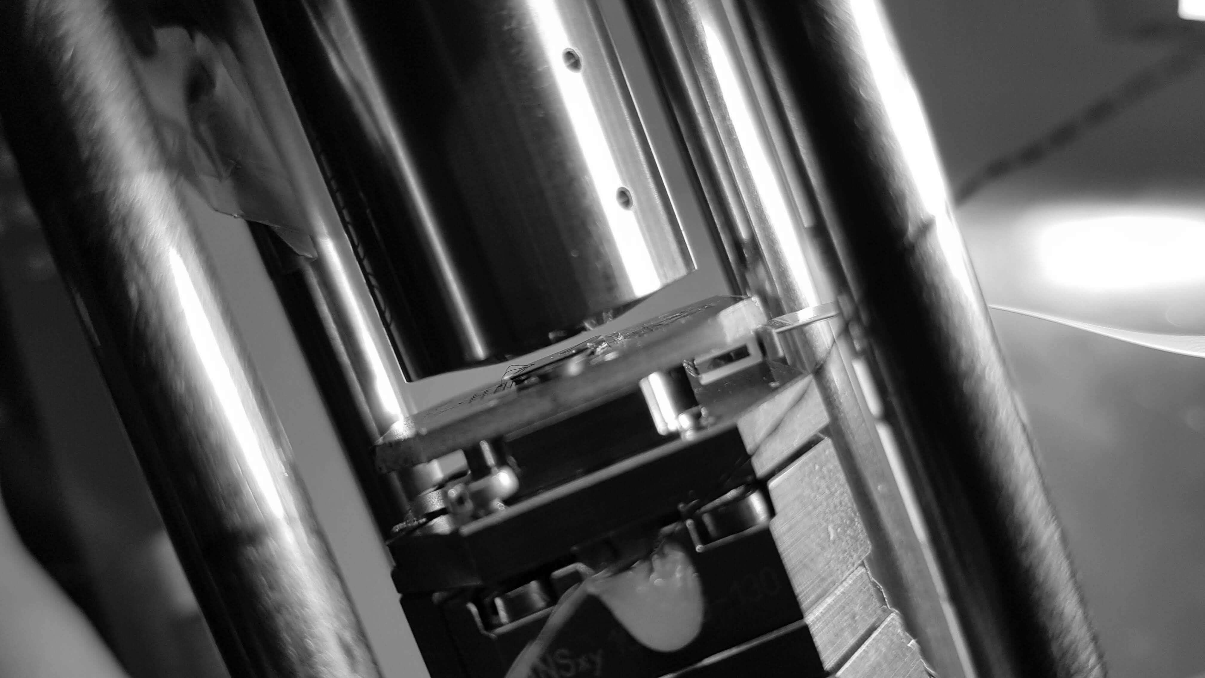 close-up of optical lab equipment, mirrors and mounts on a steel breadboard